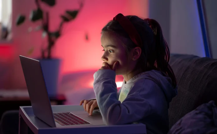 a-little-girl-uses-a-laptop-late-at-night